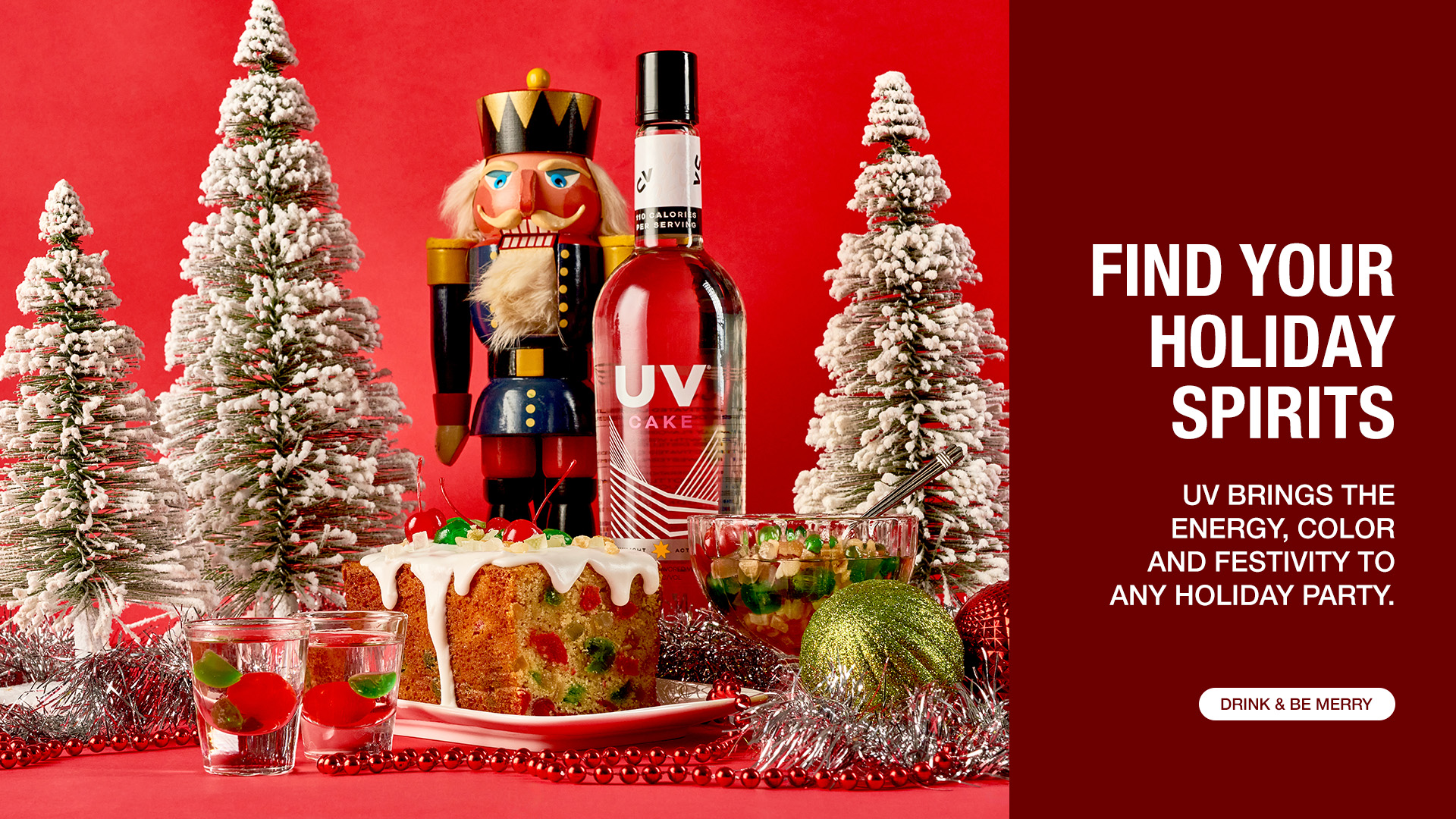 A bottle of UV cake with a fruit cake, nutcracker, and frosted Christmas tree
